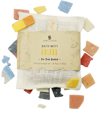 Handmade fruit soap in a bath mitt, with a label.
